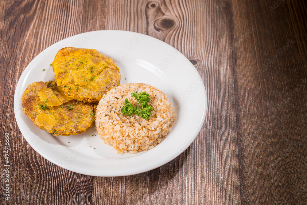 Coconut rice and plantain patacon, rice and patacon in plate Coconut rice and plantain patacon, rice and patacon in plate