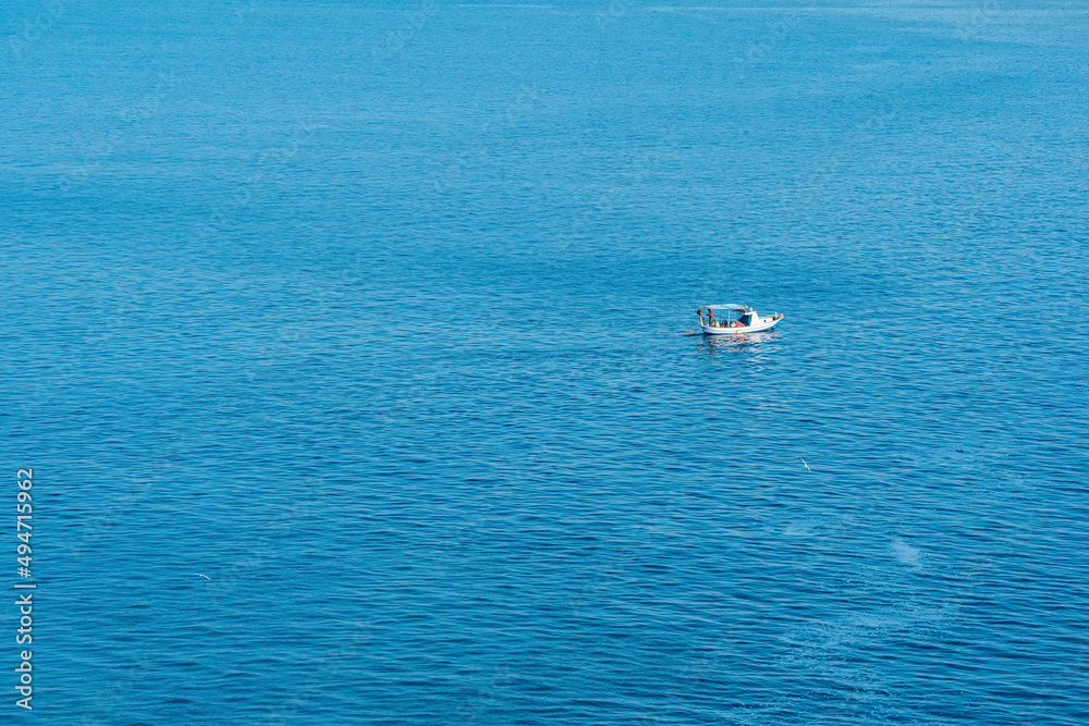 Fototapeta premium seascape with a lonely fishing boat, view from above