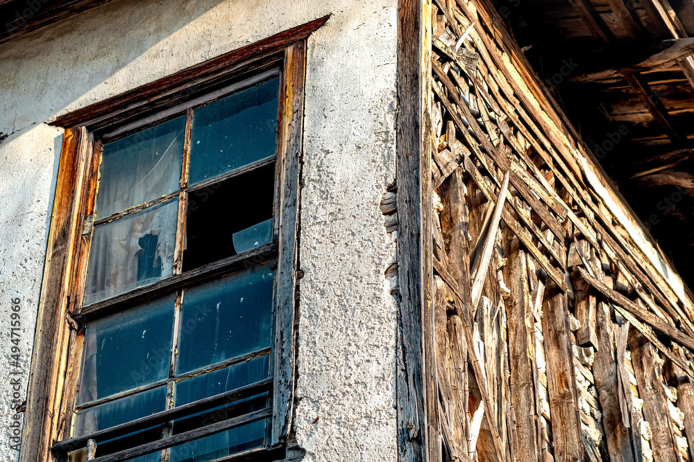 old abandoned wooden house with broken glass, fragment