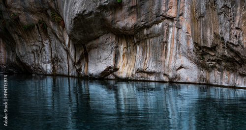 Fototapeta Naklejka Na Ścianę i Meble -  clean blue river with rocky banks at the bottom of a deep canyon