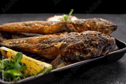 Fried fish Black Sea goby, on a dark background