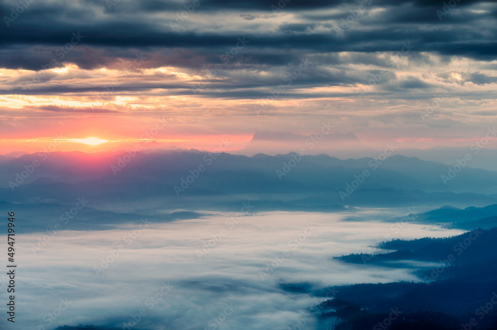 Fototapeta premium Beautiful sunrise over mountain with Doi Luang Chiang Dao peak and foggy in the valley at national park