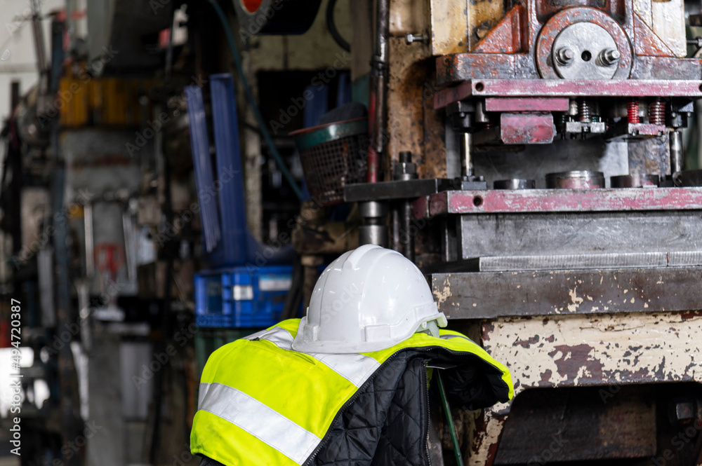 protect safety helmet and safety Vest hang on a chair engineering machine in industrial factory protect safety helmet and safety Vest hang on a chair engineering machine in industrial factory
