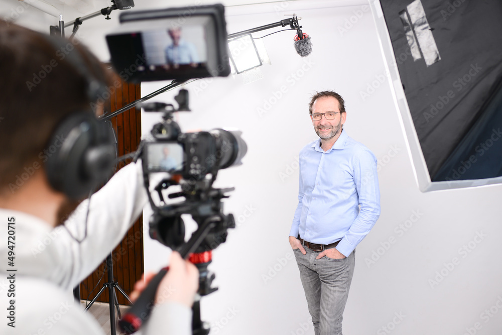 young man video camera operator making interview in professionnal broadcast tv movie studio film production young man video camera operator making interview in professionnal broadcast tv movie studio film production