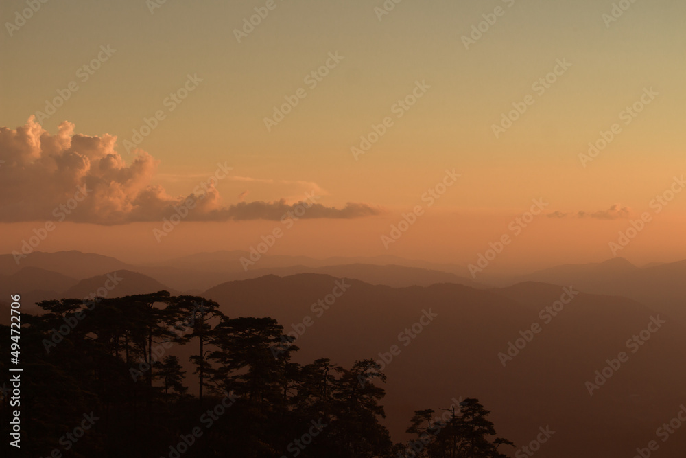 sunset with mountains in the background