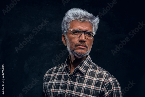 Handsome elder man with glasses looking at camera