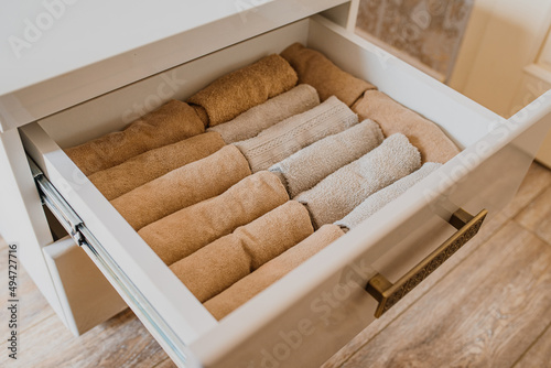 close up of an open drawer with folded towels..