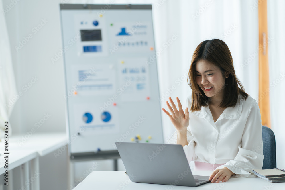 remote job, technology and people concept - happy smiling young woman with laptop computer having video call and waving hand at home office remote job, technology and people concept - happy smiling young woman with laptop computer having video call and waving hand at home office