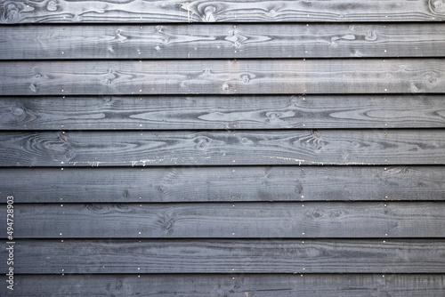 Black wooden fence in yard