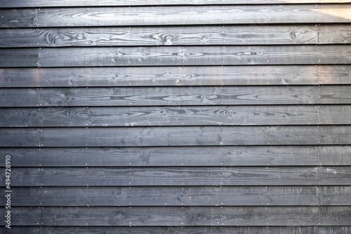 Black wooden fence in yard