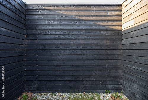 Black wooden fence in yard