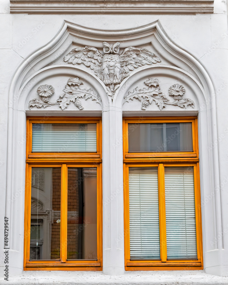 A couple of art nouveau house windows with decorated frame, Saxony, Germany A couple of art nouveau house windows with decorated frame, Saxony, Germany
