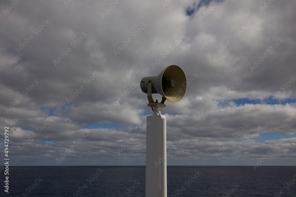 Megaphone horn at sea with clouds and sky