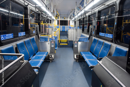 Fototapet Interior of lighted city bus at night transit