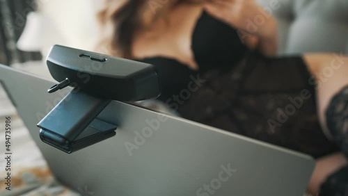 Seductive woman working as webcam model.