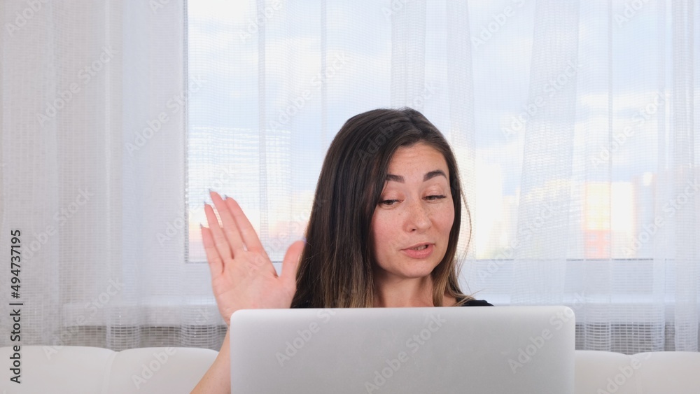 brunette girl blogger talking with friends on social networks on laptop using wireless internet. Positive young woman shopping online on the website brunette girl blogger talking with friends on social networks on laptop using wireless internet. Positive young woman shopping online on the website