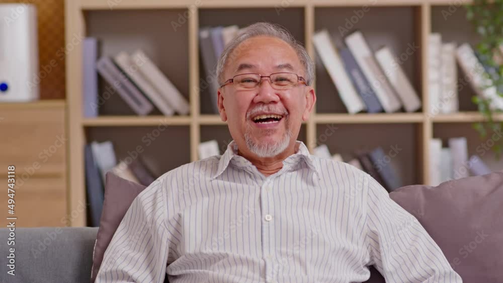 Camera view of Happiness elderly asian man sitting on sofa and using computer laptop video call Conference online meeting with family or business team and smile at home,Senior lifestyle at home Camera view of Happiness elderly asian man sitting on sofa and using computer laptop video call Conference online meeting with family or business team and smile at home,Senior lifestyle at home