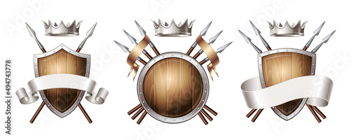 Graphic emblem composed using majestic crown, protection shield, crossed spears and ribbon.