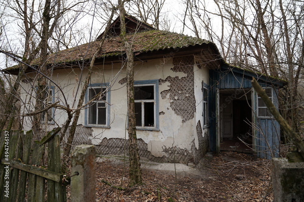 Abandoned damaged house in Chernobyl exclusion zone surrounding nuclear power plant with high