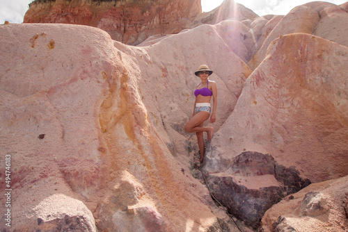 Fit Woman standing at the Colorful Red Cliffs known as the Falesias near Arraial d’ Ajuda, Bahia, Brazil

 photo