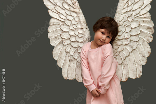 Cute little girl with angel wings on her back. Copy space.