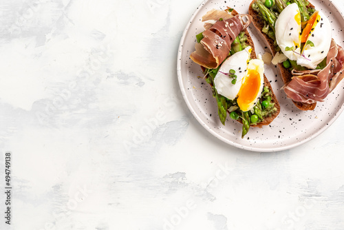 Ketogenic diet meal Poached egg with asparagus spears and prosciutto. banner, menu recipe place for text, top view