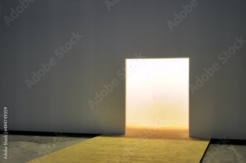 White wall with open doorway to luminous empty space