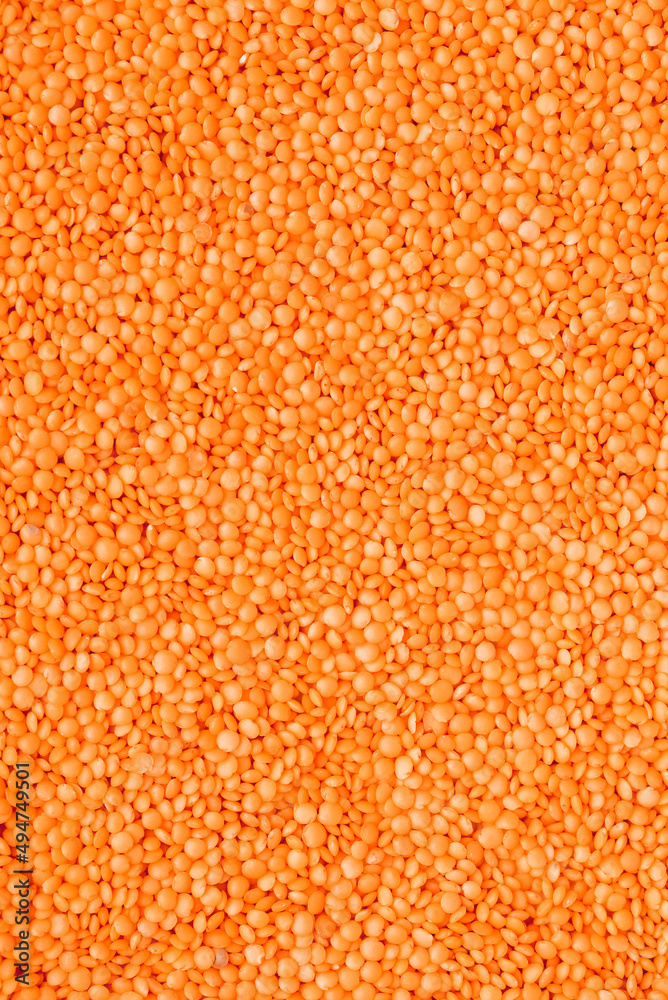 Scattered raw red lentils as background texture