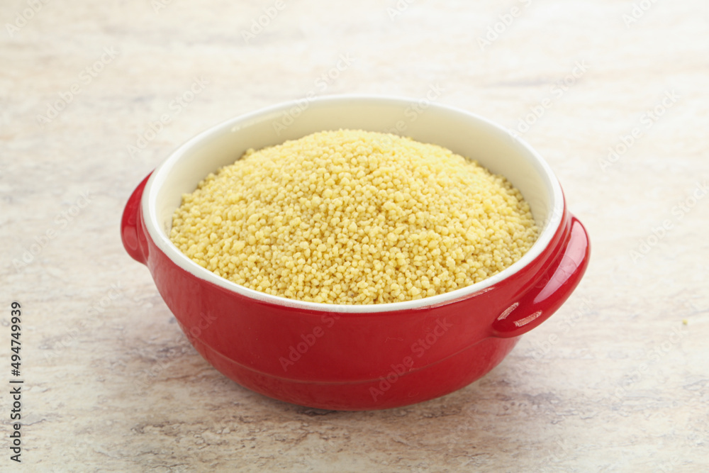 Raw couscous in the bowl Raw couscous in the bowl