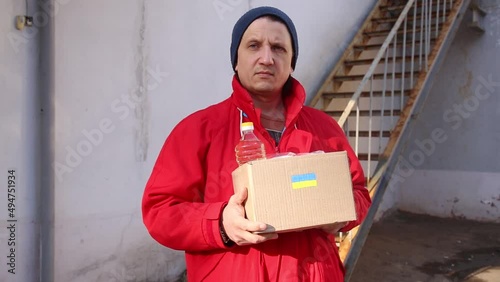 Volunteer preparing food box for ukrainian war refugees - Humanitarian help and aid concept