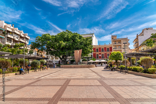 Constitution Square in the center of Fuengirola city with view of the "Monumento a la Familia". Famous plaza in old town center of the city.