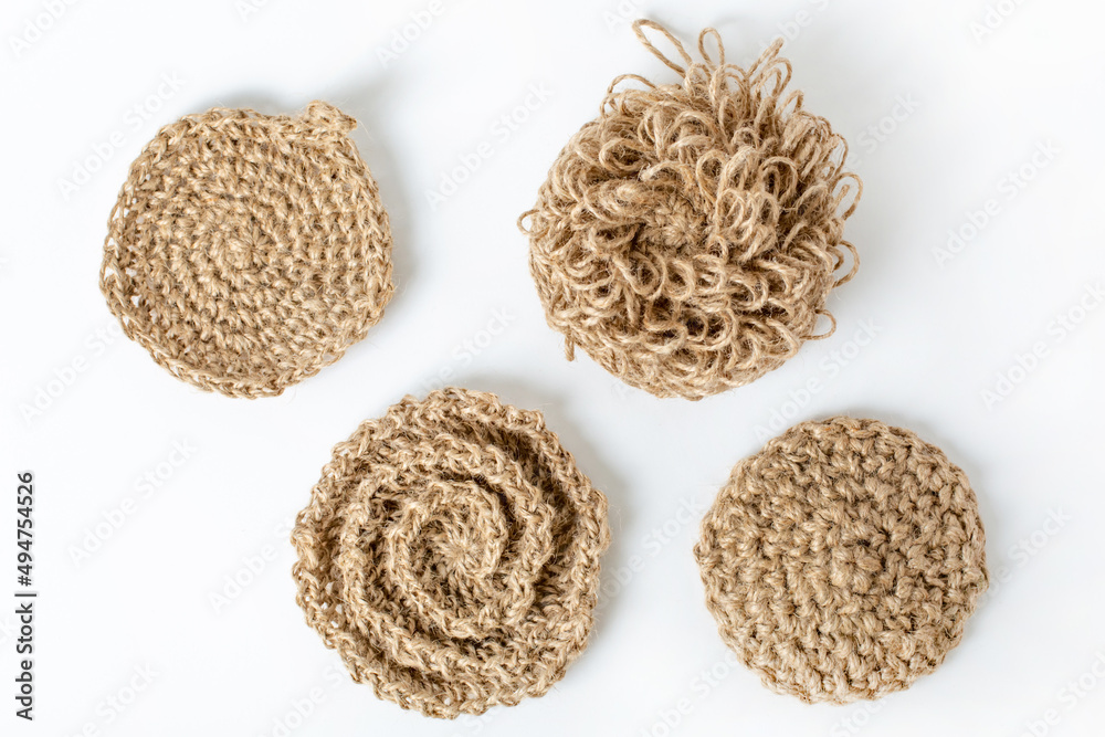 Natural washcloth made of craft thread for washing dishes. The concept of waste-free production , zero waste on white background isolated Natural washcloth made of craft thread for washing dishes. The concept of waste-free production , zero waste on white background isolated