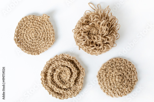 Natural washcloth made of craft thread for washing dishes. The concept of waste-free production , zero waste on white background isolated  photo