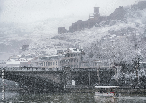 Snowy Tbilisi, Georgia. The central part of the Old City in the snow. Narikala Fortress and Metekhi bridge over Kura river. 
