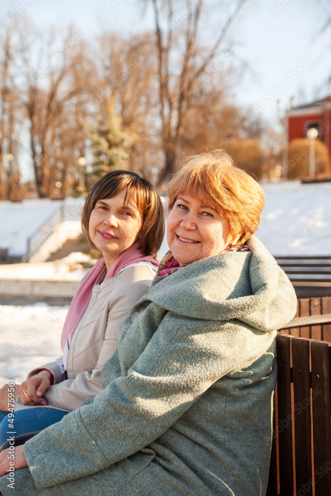 Fototapeta premium Middle-aged women on walk in spring park