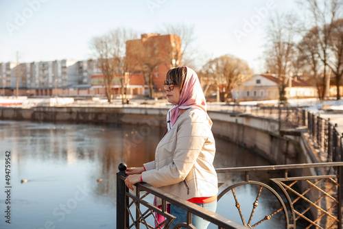 Contemplative casual senior woman looking away at embankment photo