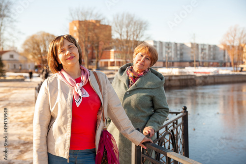 Сasual senior women looking away at embankment photo