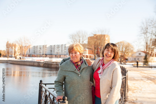 Сasual senior women looking away at embankment photo