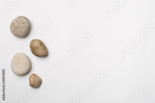 Set of sea stones on wooden background, top view