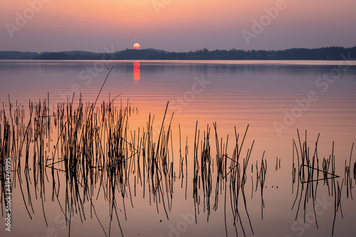 Colorful sunset in spring at lake Kellersee, Malente Eutin, Schleswig-Holstein, Northern Germany 