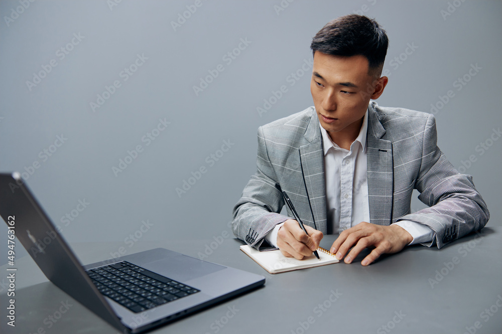 manager writing in a notebook laptop work at the desktop executive manager writing in a notebook laptop work at the desktop executive