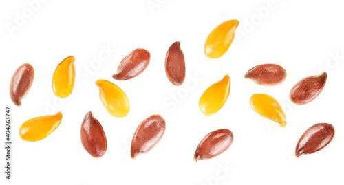 Brown and golden flax seeds isolated on a white background, top view. Macro.