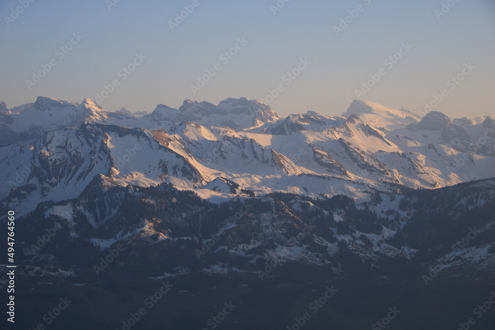 Distant view of Mount Titlis and other snow covered mountains.