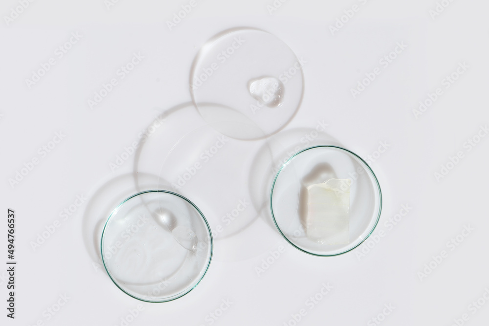 Glass petri dish with transparent pure serum for skin care Glass petri dish with transparent pure serum for skin care