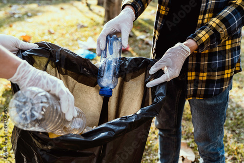 Collecting the garbage and separating waste to freshen the problem of environmental pollution and global warming, plastic waste, care for nature. Volunteer concept of men carrying garbage bags © crizzystudio