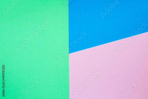 Abstract background with colored paper blue with pink and green color.