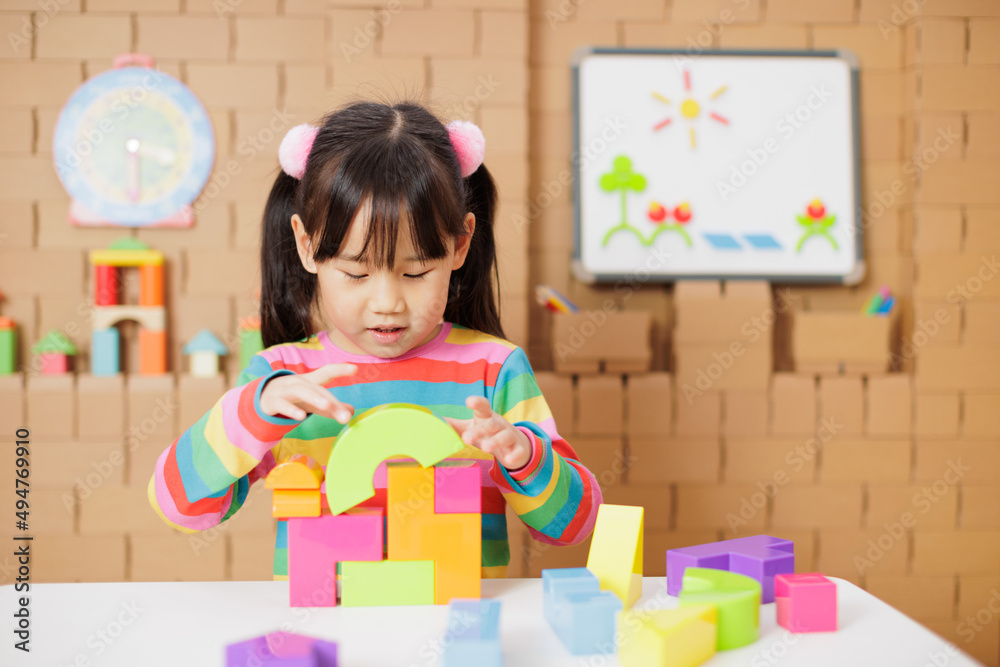 young girl playing creative toy blocks at home young girl playing creative toy blocks at home