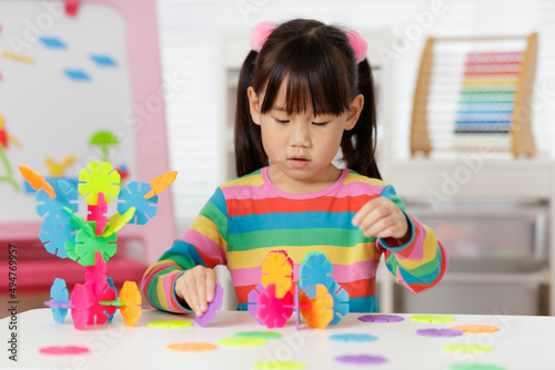 young irl playing creative toy blocks at home