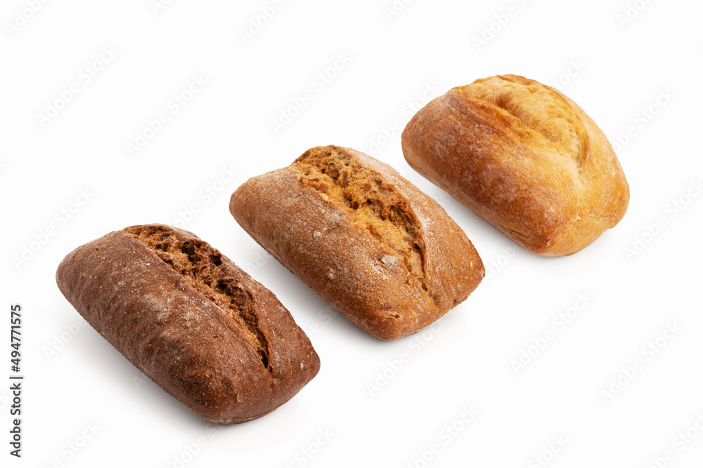 Freshly baked buns of different sorts wheat and rye isolated on a white background with shadow Freshly baked buns of different sorts wheat and rye isolated on a white background with shadow