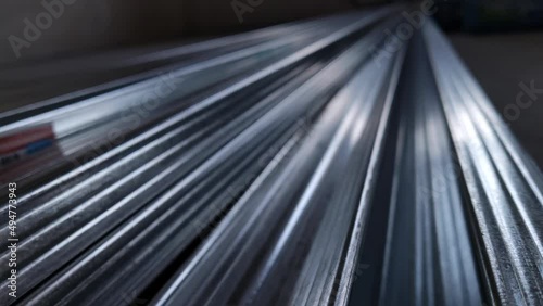 Metal profiles. Stack of stainless steel pipes in warehouse. Rolled metal products. Economic Metals list prices index. Financial crisis. Wall building parts.